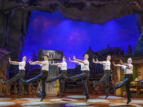 Production shot of The Book of Mormon in London featuring the 'Mormons' ensemble.