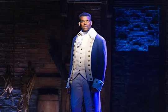 Production shot of Hamilton in London, with Michael Jibson as King George.